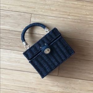 Black woven handle bag with gold hardware